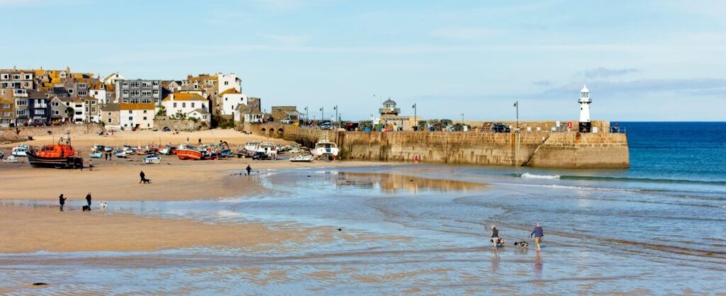 Boats and lighthouse at St Ives harbour